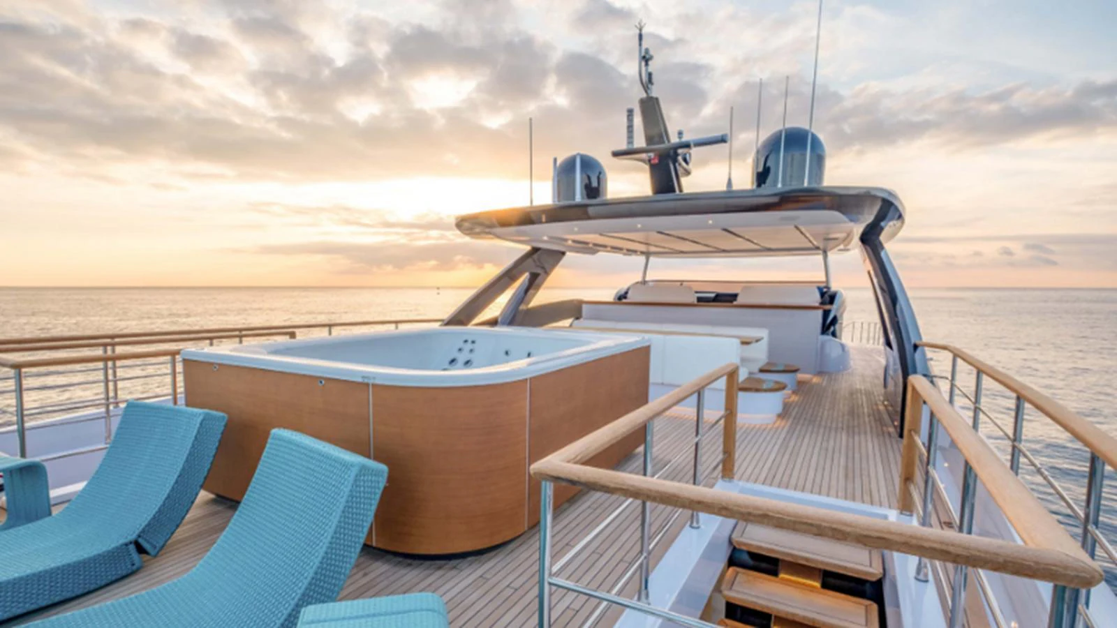 The sundeck features a luxurious hot tub and stylish lounge chairs, perfect for relaxation while enjoying the sunset. aboard NEW Yacht for Sale