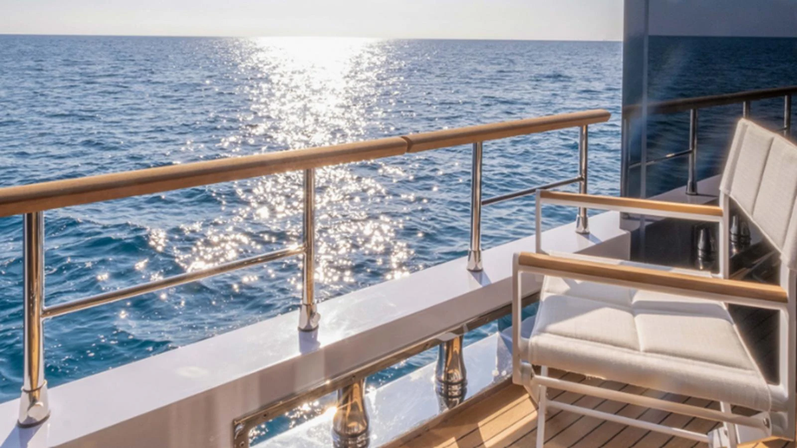 The aft deck offers a serene view of the ocean with comfortable seating to enjoy the surroundings. aboard NEW Yacht for Sale
