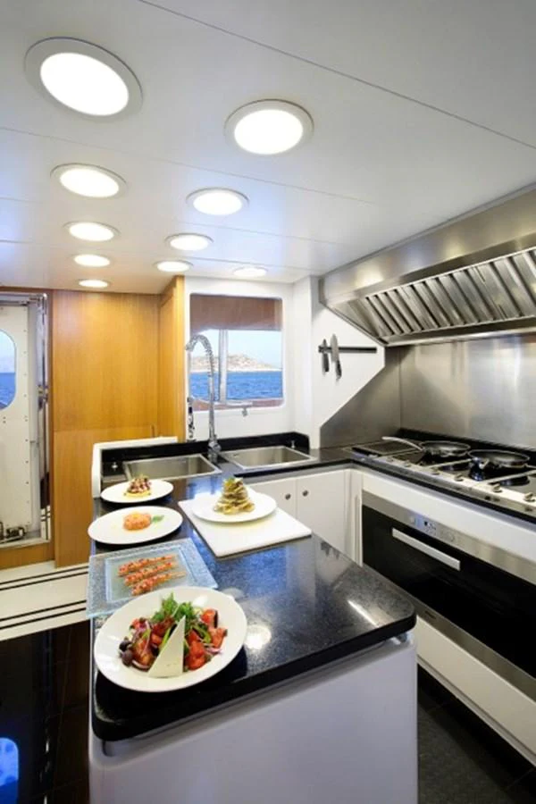 a kitchen with a large island aboard MILOS AT SEA Yacht for Sale