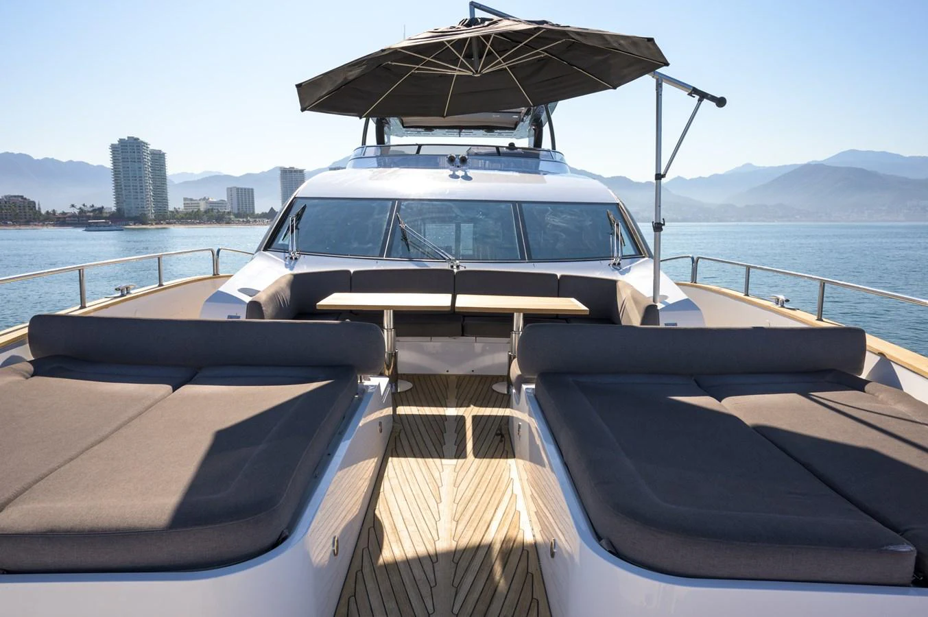 The foredeck features luxurious sun loungers and a shaded seating area, perfect for relaxation. aboard EBRA Yacht for Sale