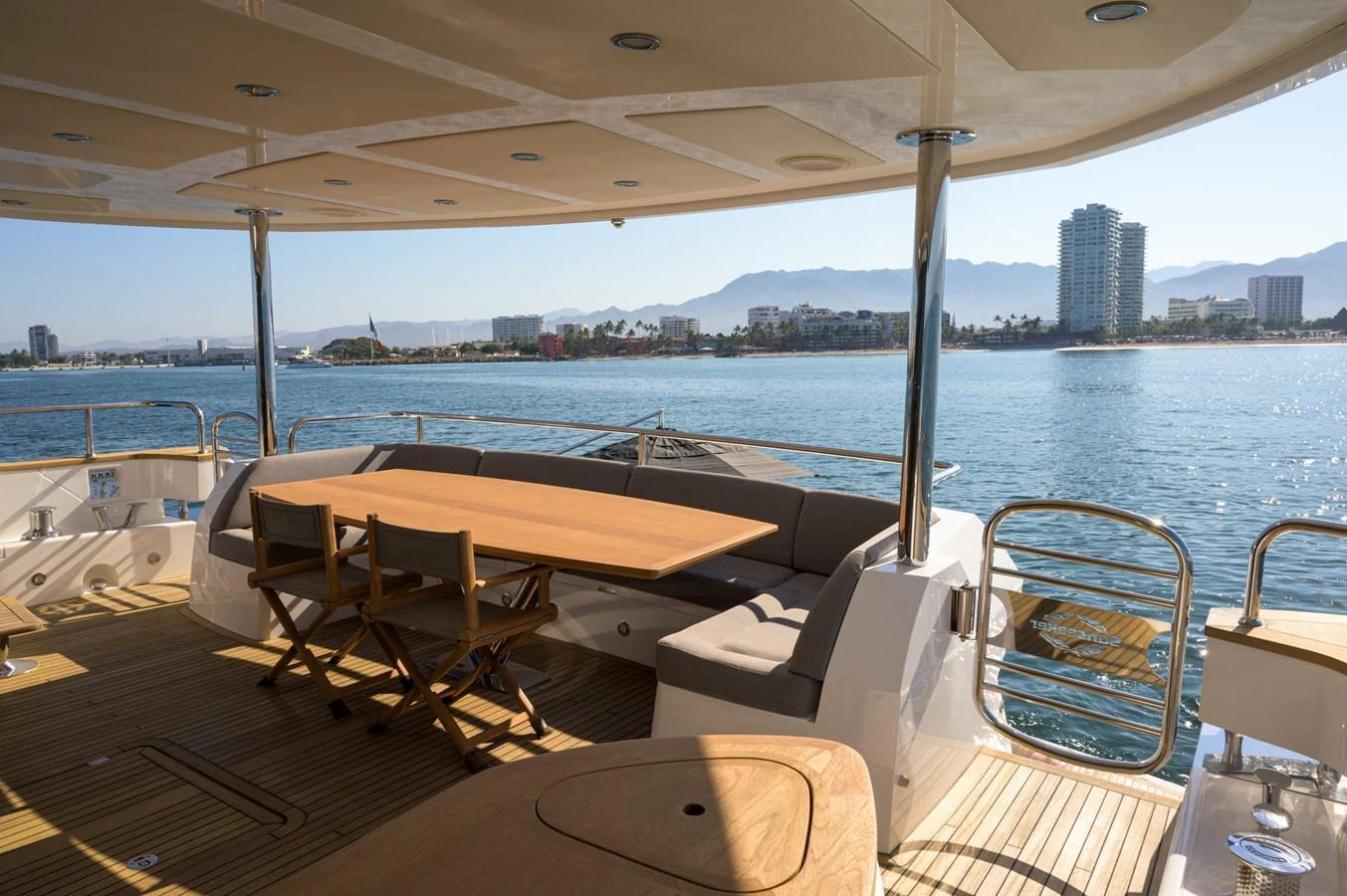The aft deck offers a spacious and inviting area with a dining table and comfortable seating, perfect for enjoying the scenic views. aboard EBRA Yacht for Sale