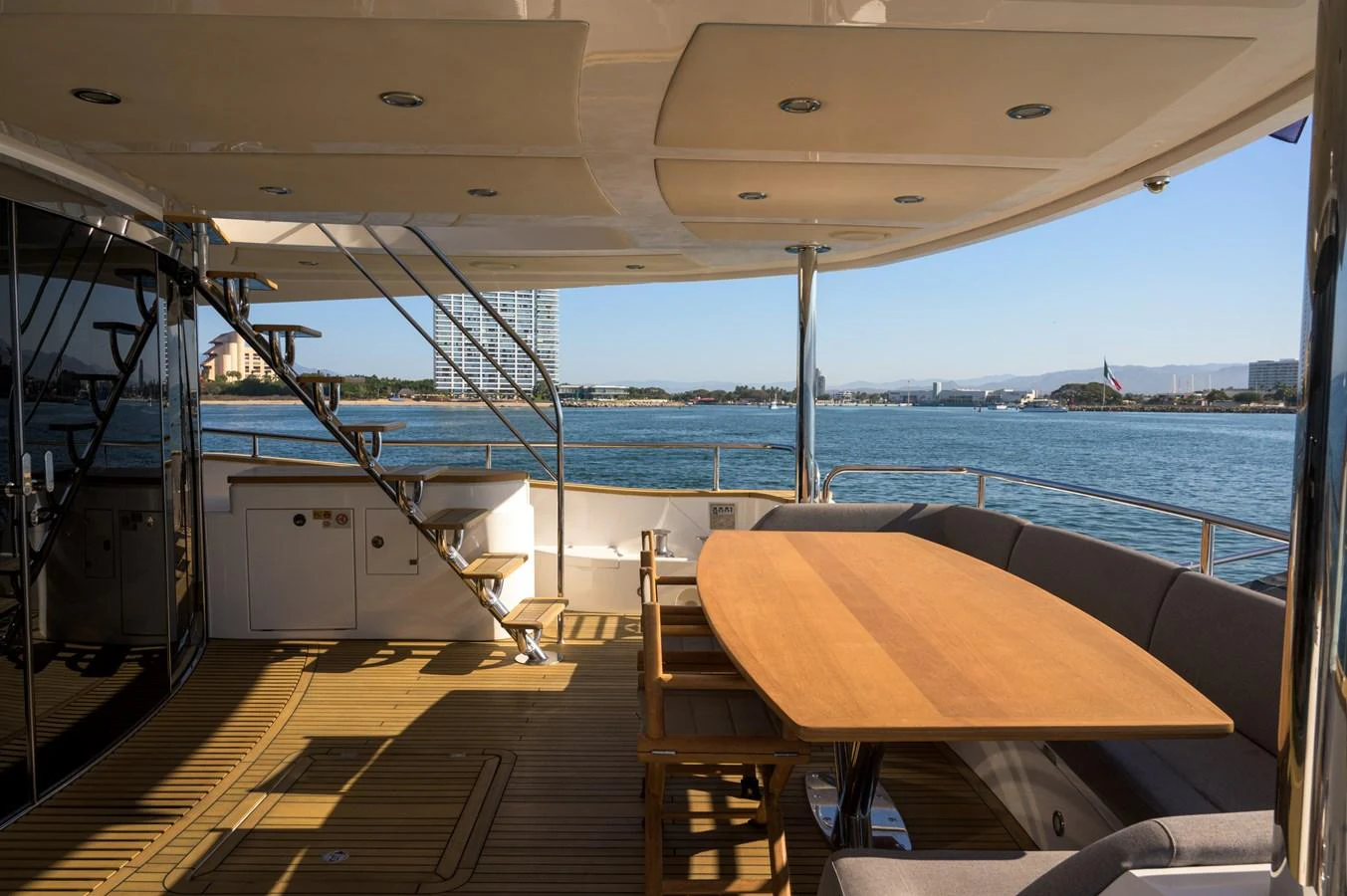 The aft deck offers a spacious and shaded area for alfresco dining with stunning views of the water. aboard EBRA Yacht for Sale