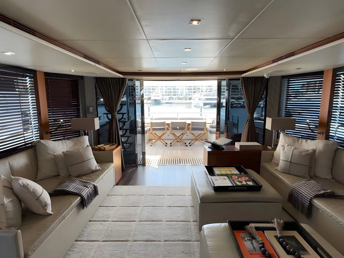 The salon offers a spacious and inviting area with comfortable seating and a view of the aft deck. aboard EBRA Yacht for Sale