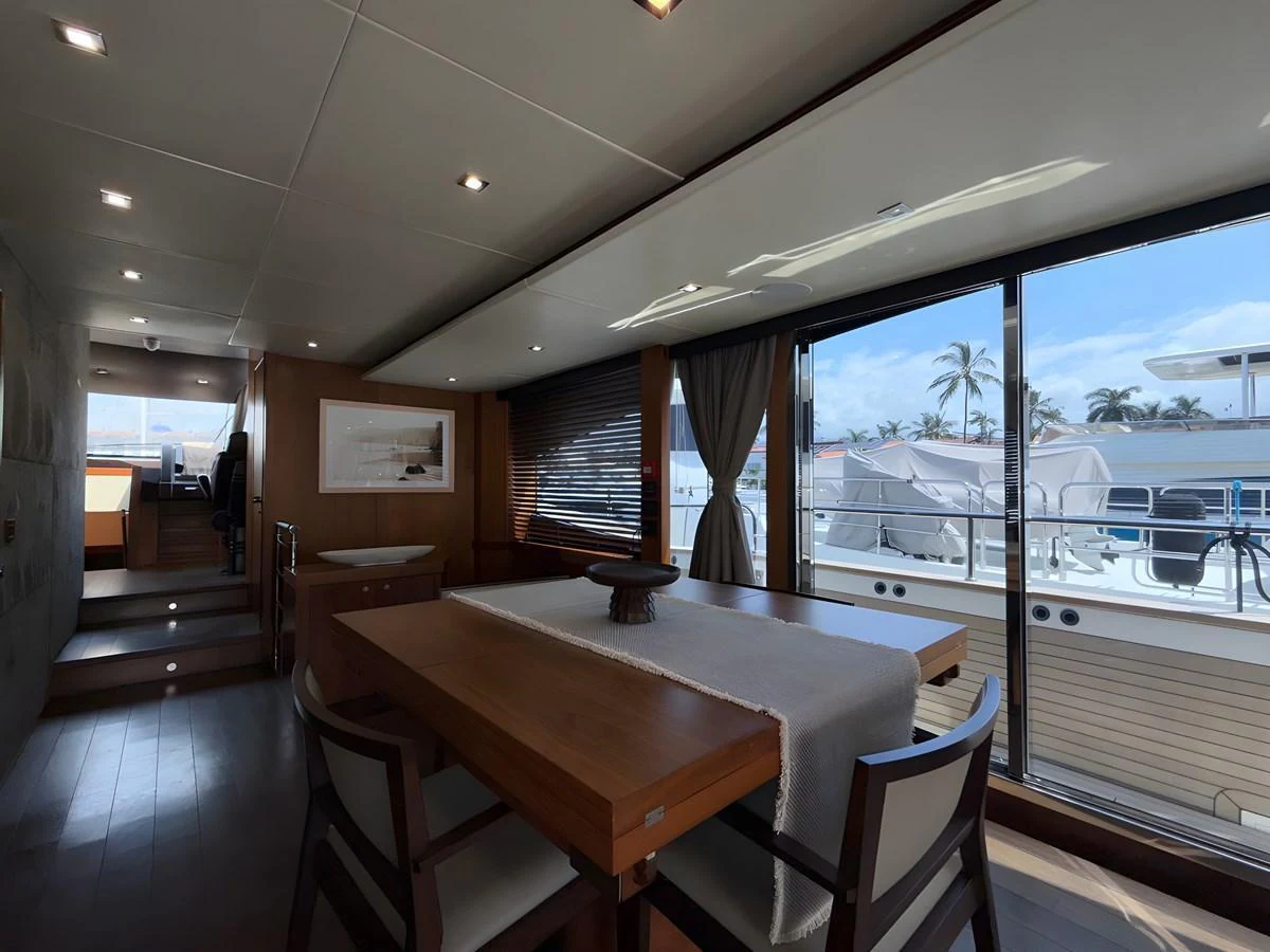 The yacht's dining area offers a sophisticated space with ample natural light and elegant furnishings. aboard EBRA Yacht for Sale