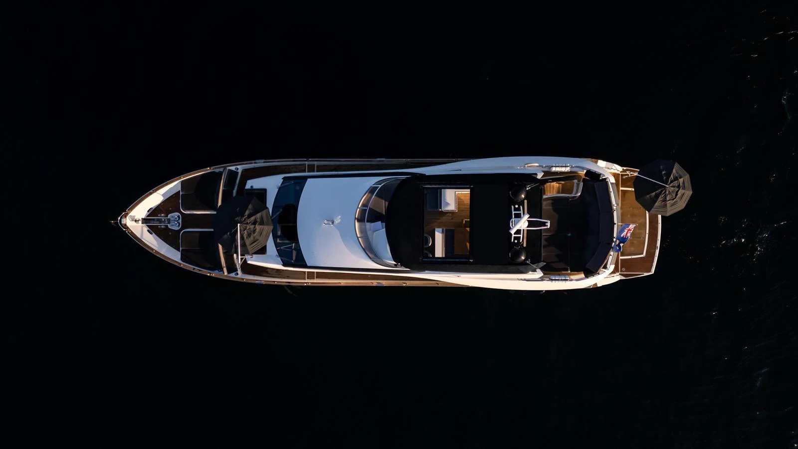 A sleek yacht is captured from an aerial view, showcasing its elegant design and spacious deck areas. aboard EBRA Yacht for Sale