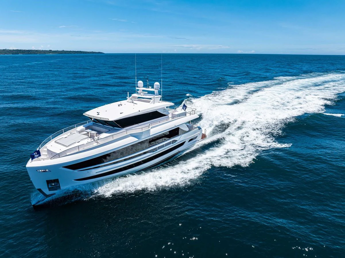 A sleek and modern yacht cruises swiftly through the open sea under a clear blue sky. aboard HORIZON FD80-617 / COMING FALL 2025 Yacht for Sale
