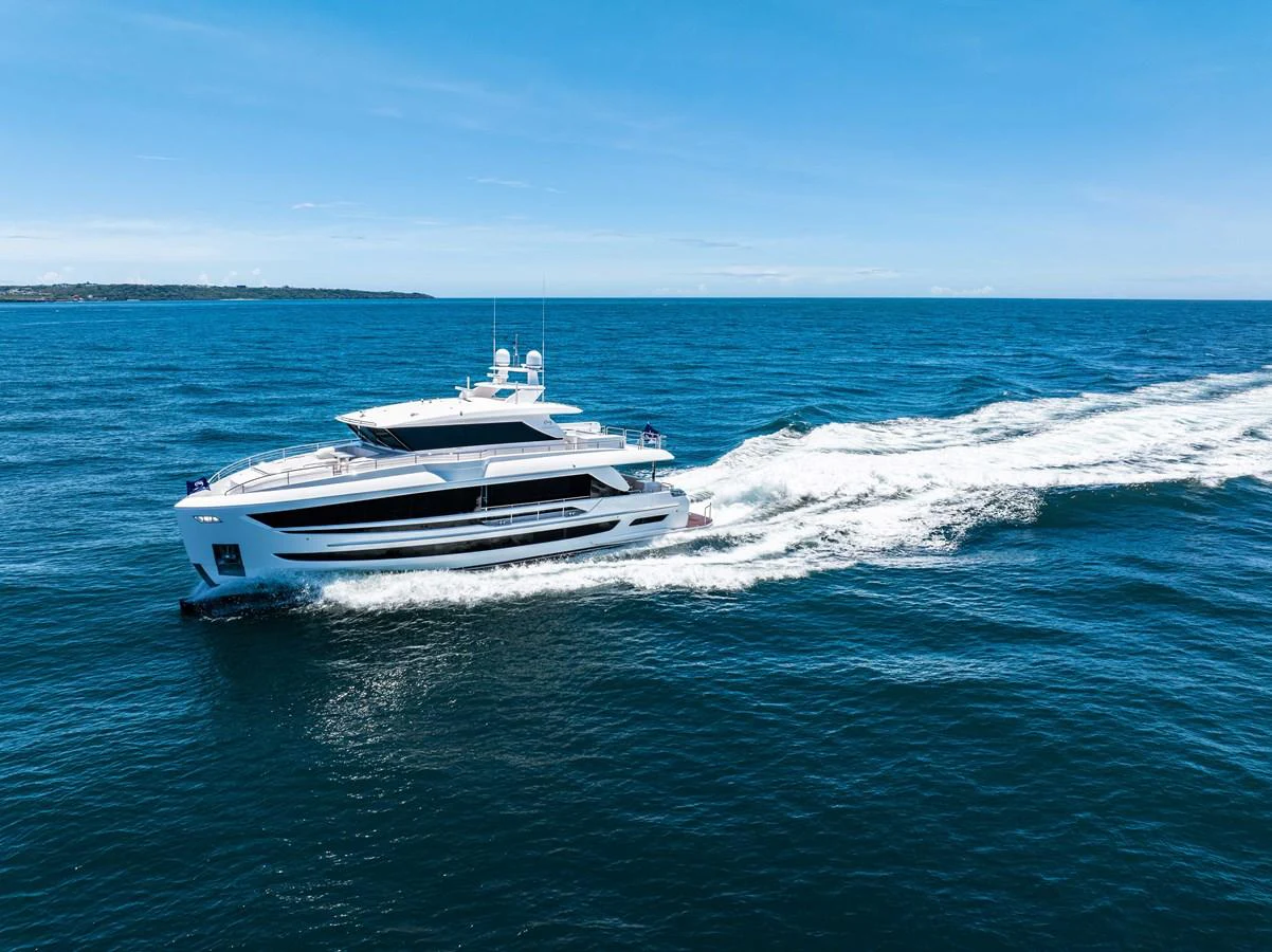 A sleek and modern yacht cruises swiftly across the open sea under a clear blue sky. aboard HORIZON FD80-617 / COMING FALL 2025 Yacht for Sale