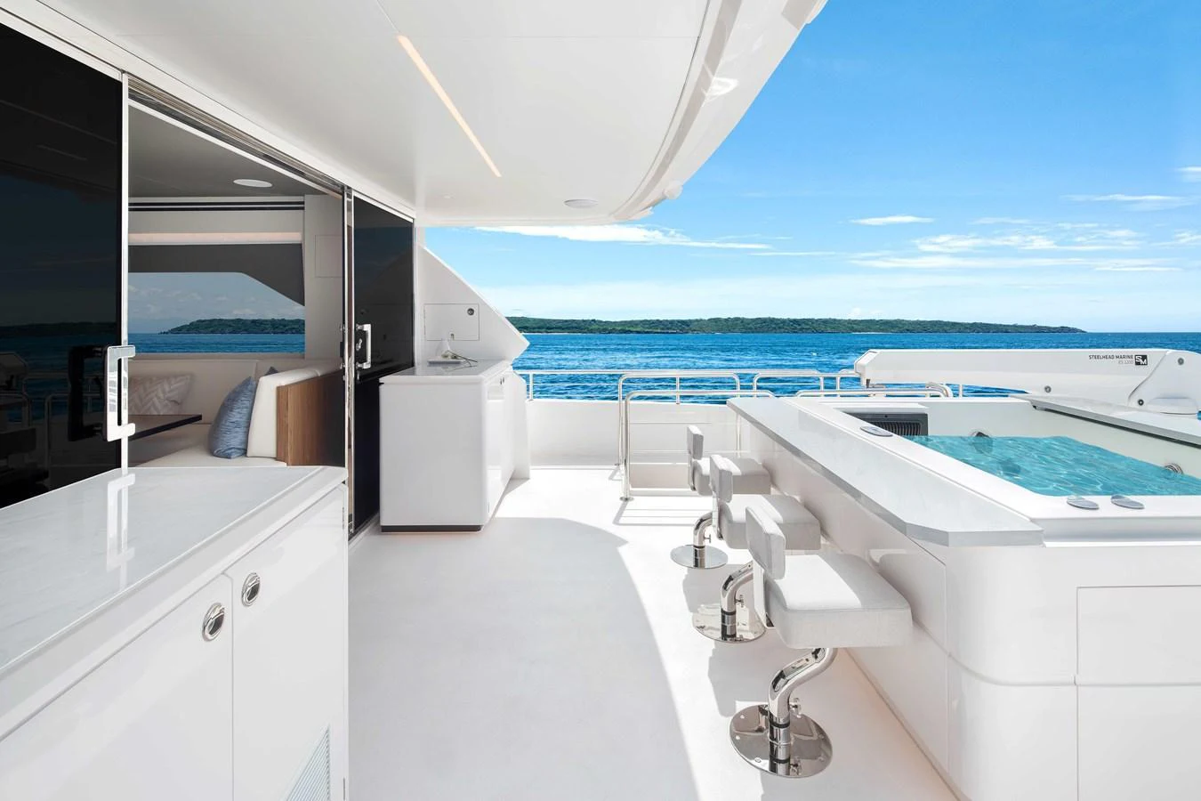 The aft deck features a luxurious jacuzzi with bar stools and a stunning ocean view. aboard HORIZON FD80-617 / COMING FALL 2025 Yacht for Sale