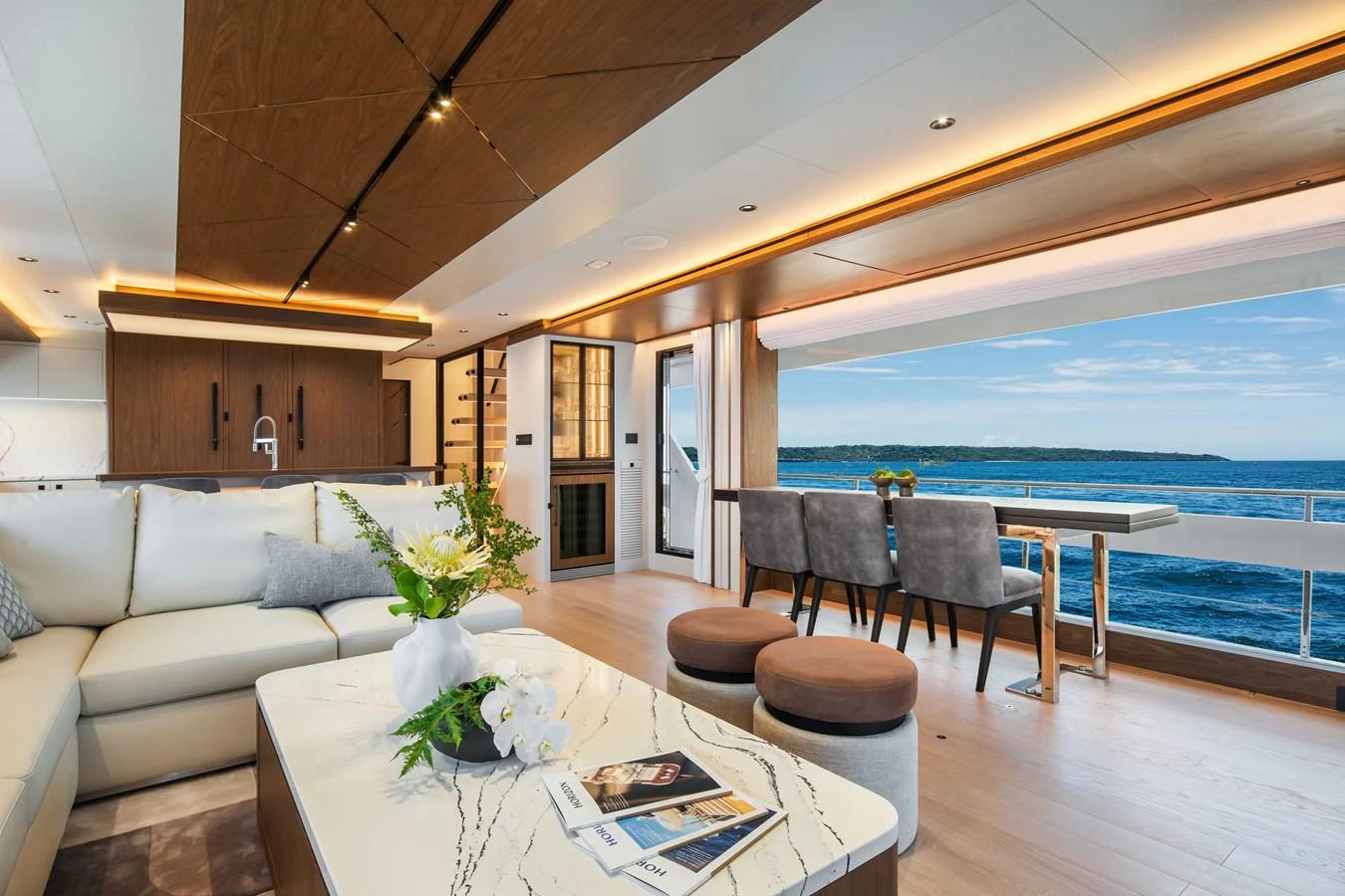 The salon offers a luxurious and spacious area with elegant furnishings and a stunning view of the sea. aboard HORIZON FD80-617 / COMING FALL 2025 Yacht for Sale