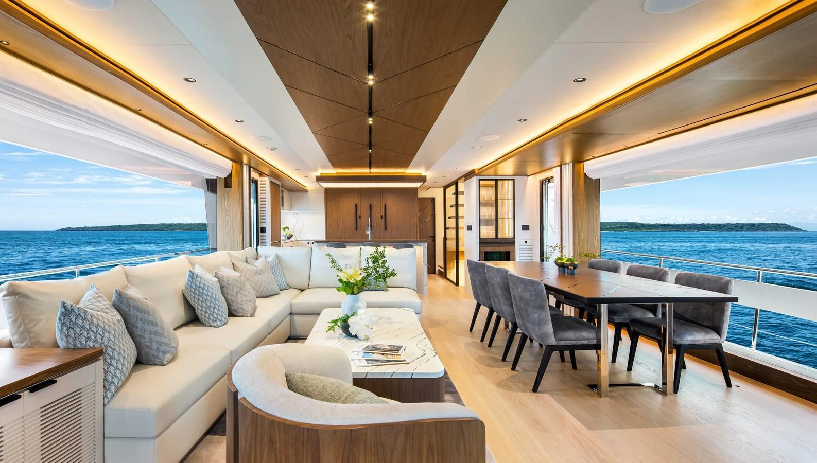 The spacious salon features elegant seating, a dining area, and panoramic ocean views. aboard HORIZON FD80-617 / COMING FALL 2025 Yacht for Sale