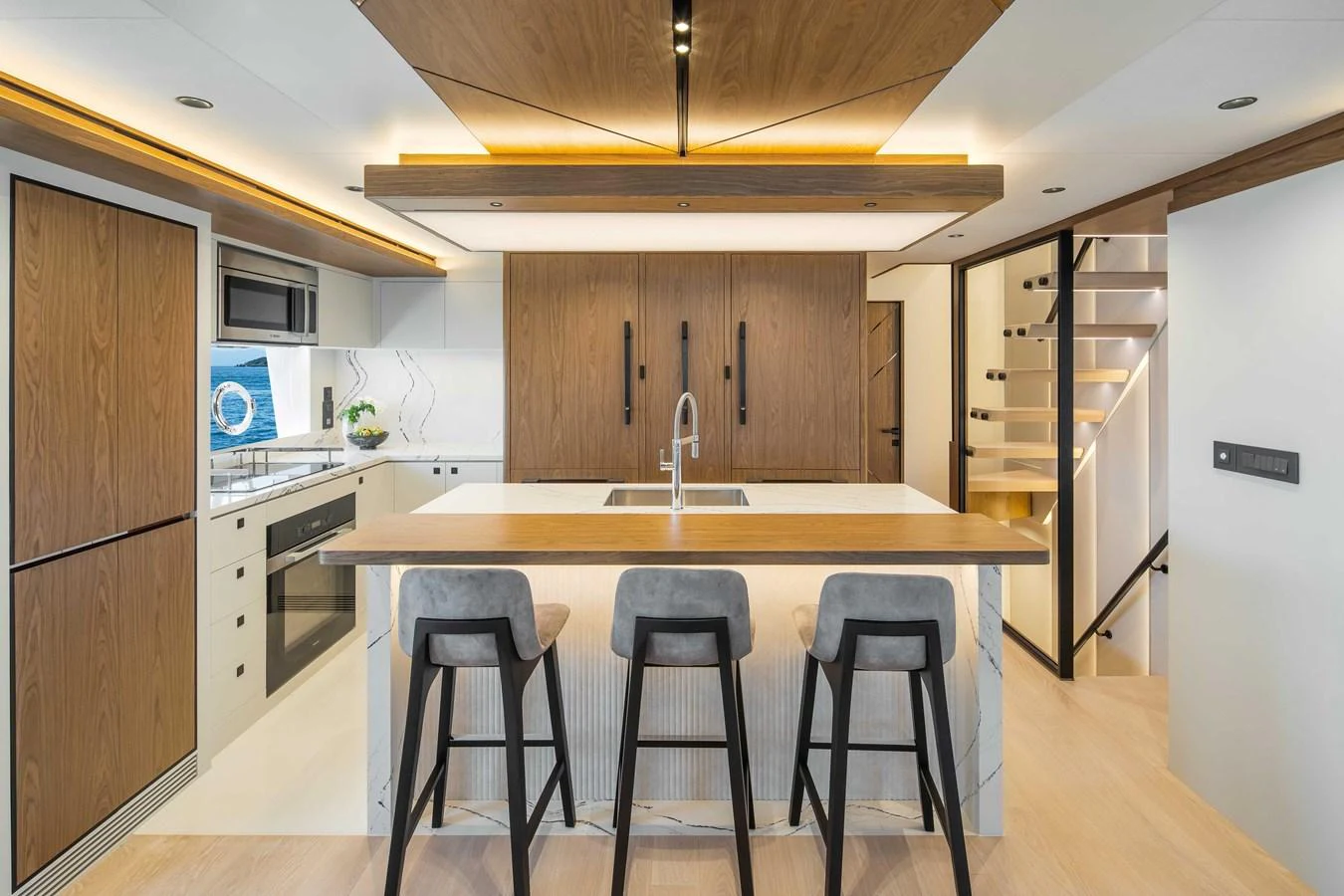 The galley features modern appliances, sleek cabinetry, and a spacious island with seating. aboard HORIZON FD80-617 / COMING FALL 2025 Yacht for Sale