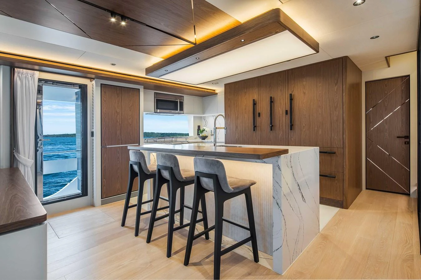 The yacht's galley features modern design with sleek cabinetry and a spacious island. aboard HORIZON FD80-617 / COMING FALL 2025 Yacht for Sale