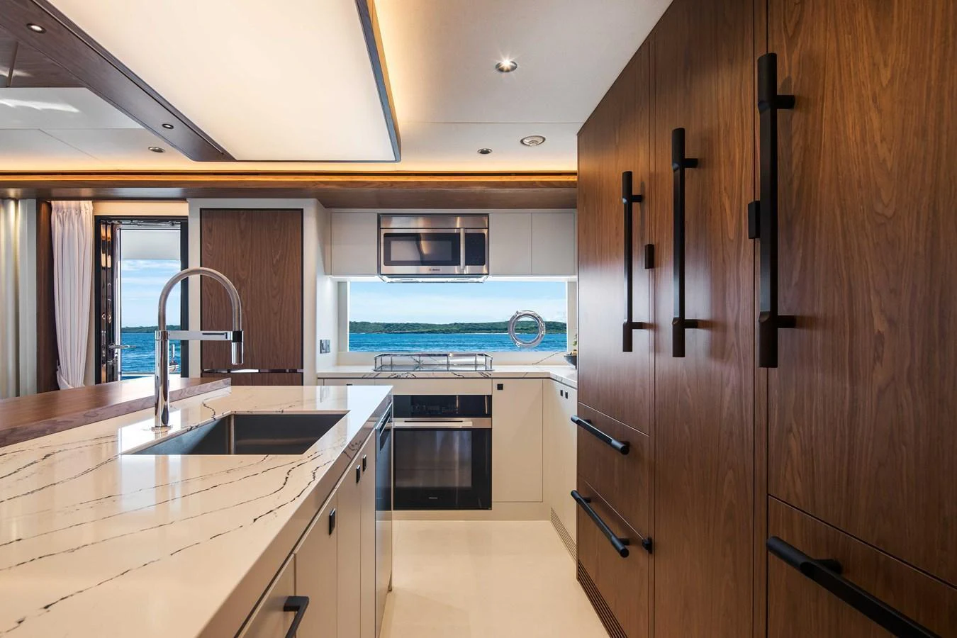 The yacht's galley features modern appliances, sleek cabinetry, and a stunning ocean view. aboard HORIZON FD80-617 / COMING FALL 2025 Yacht for Sale