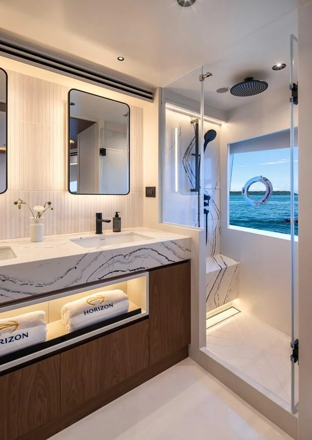 A luxurious yacht bathroom with a modern design and ocean view. aboard HORIZON FD80-617 / COMING FALL 2025 Yacht for Sale