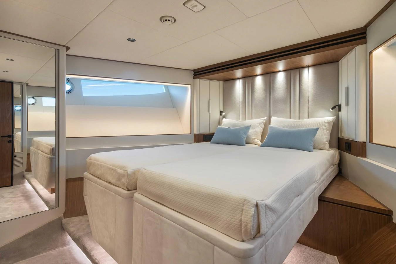 The stateroom features a luxurious double bed with elegant lighting and modern decor. aboard HORIZON FD80-617 / COMING FALL 2025 Yacht for Sale