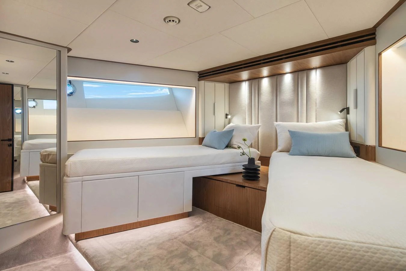 The guest stateroom features twin beds with elegant bedding and modern lighting. aboard HORIZON FD80-617 / COMING FALL 2025 Yacht for Sale