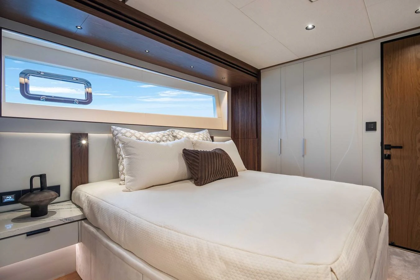 A luxurious stateroom featuring a large bed with elegant bedding and modern furnishings. aboard HORIZON FD80-617 / COMING FALL 2025 Yacht for Sale