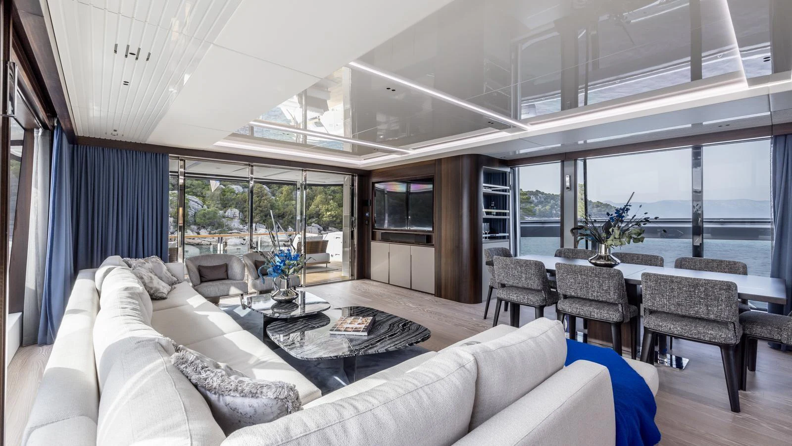 a living room with a large glass window aboard EXIT Yacht for Sale