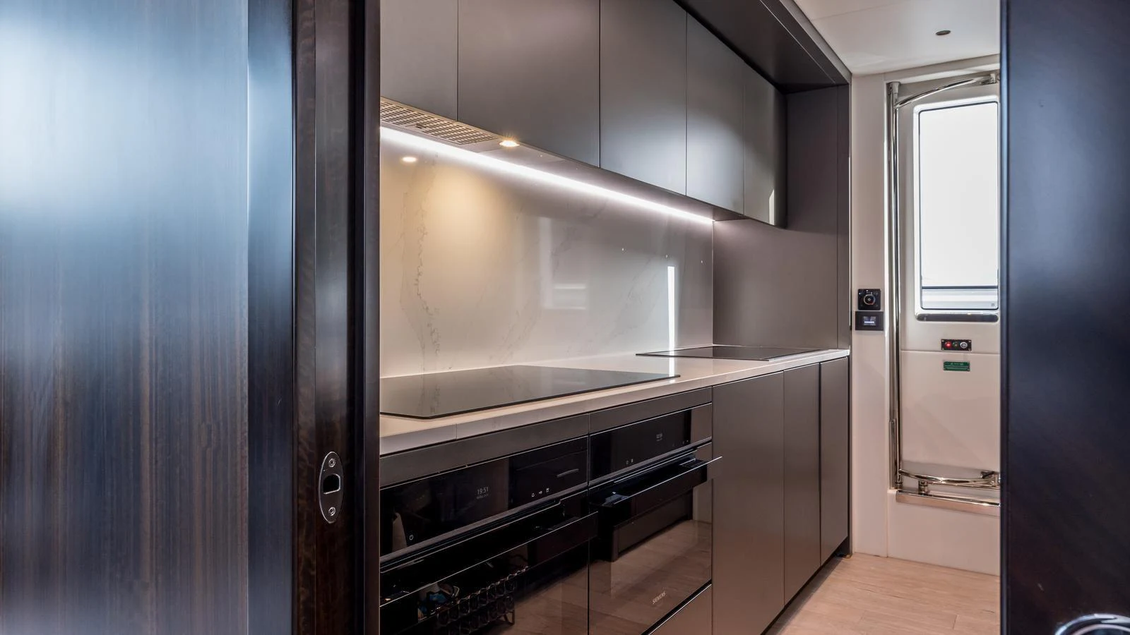 a kitchen with a large stainless steel counter and cabinets aboard EXIT Yacht for Sale
