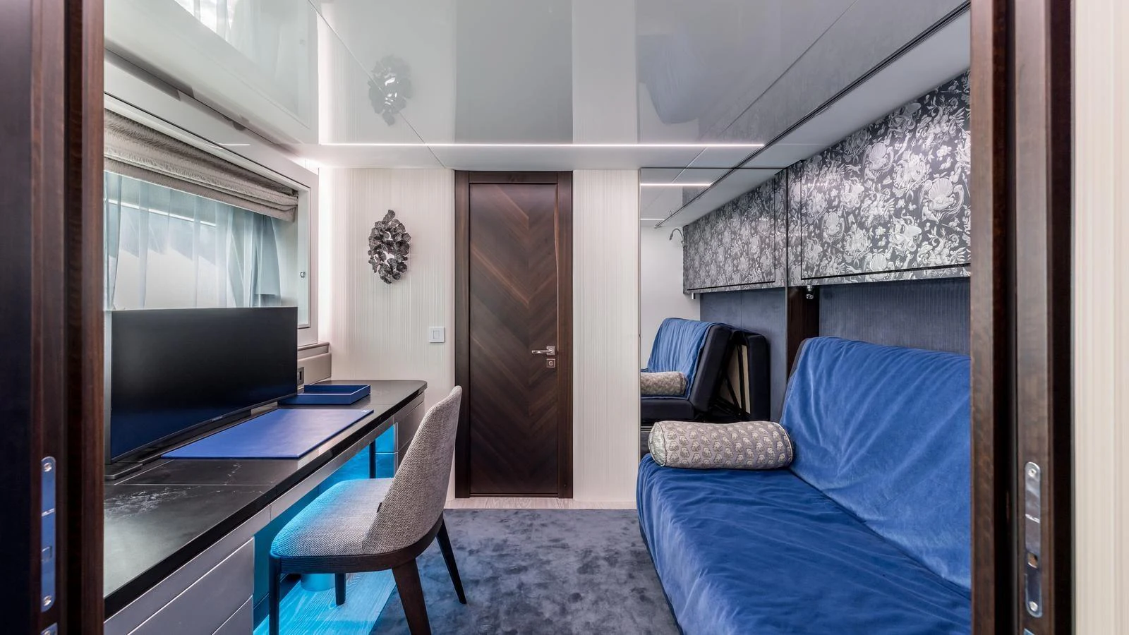 a bedroom with a bed and a desk aboard EXIT Yacht for Sale