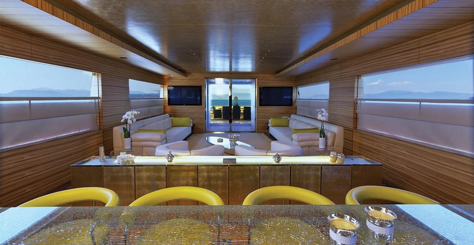 The salon features luxurious seating with panoramic views and elegant decor. aboard MABROUK Yacht for Sale