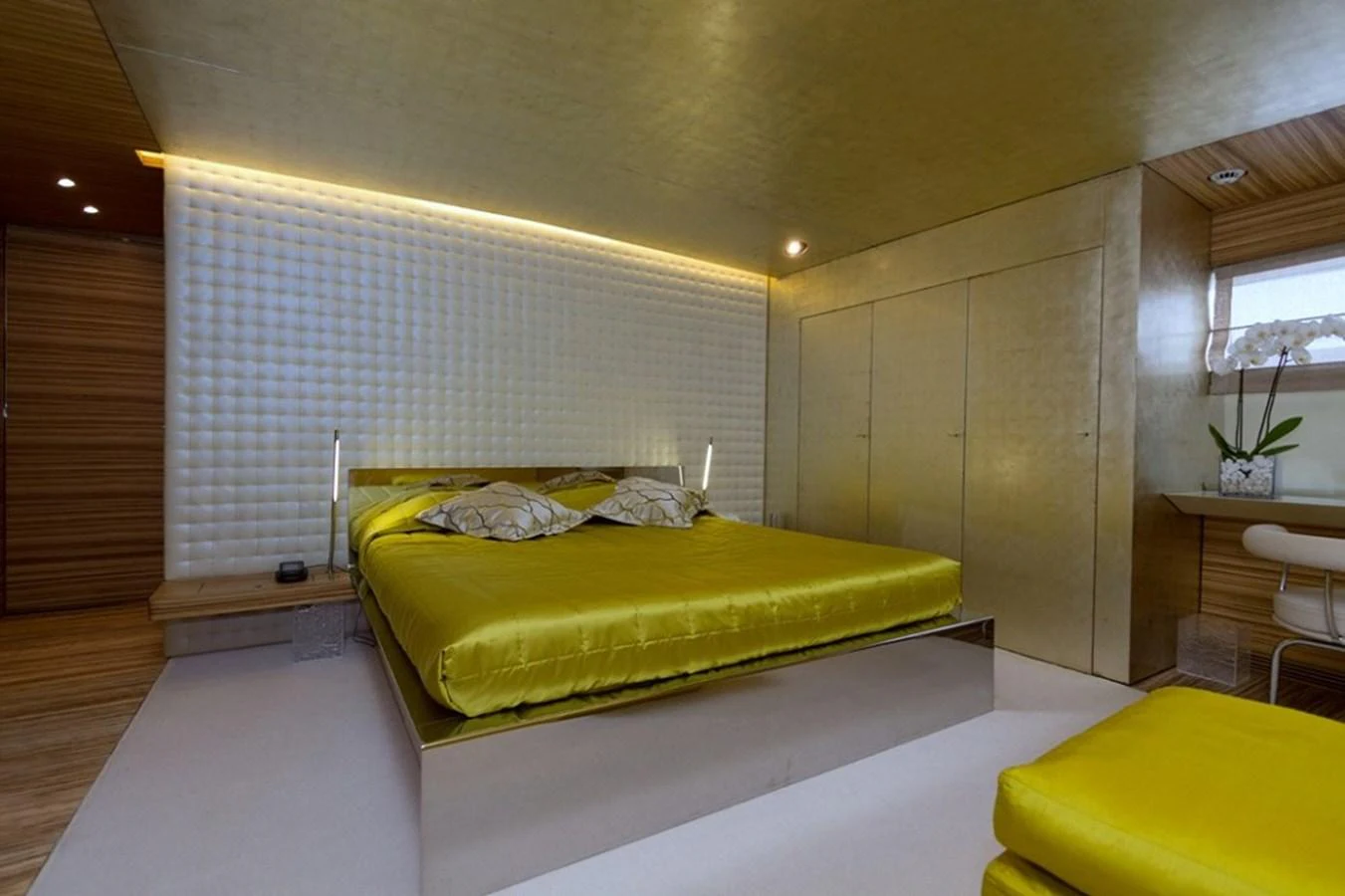 The master stateroom features a luxurious bed with modern decor and ambient lighting. aboard MABROUK Yacht for Sale