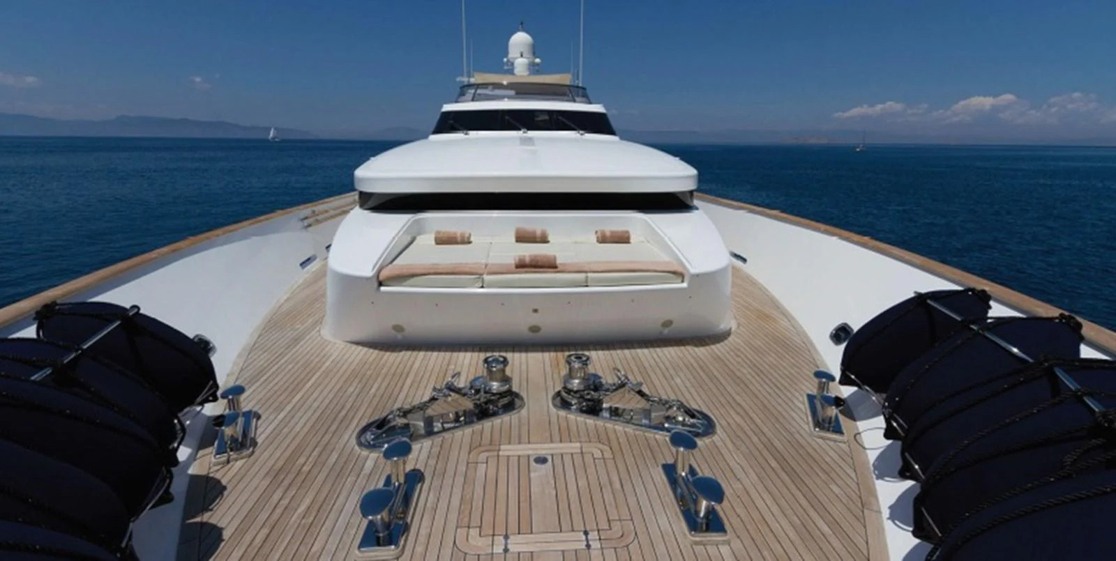 The foredeck of the yacht features a spacious sunbathing area with plush cushions and a sleek, modern design. aboard MABROUK Yacht for Sale