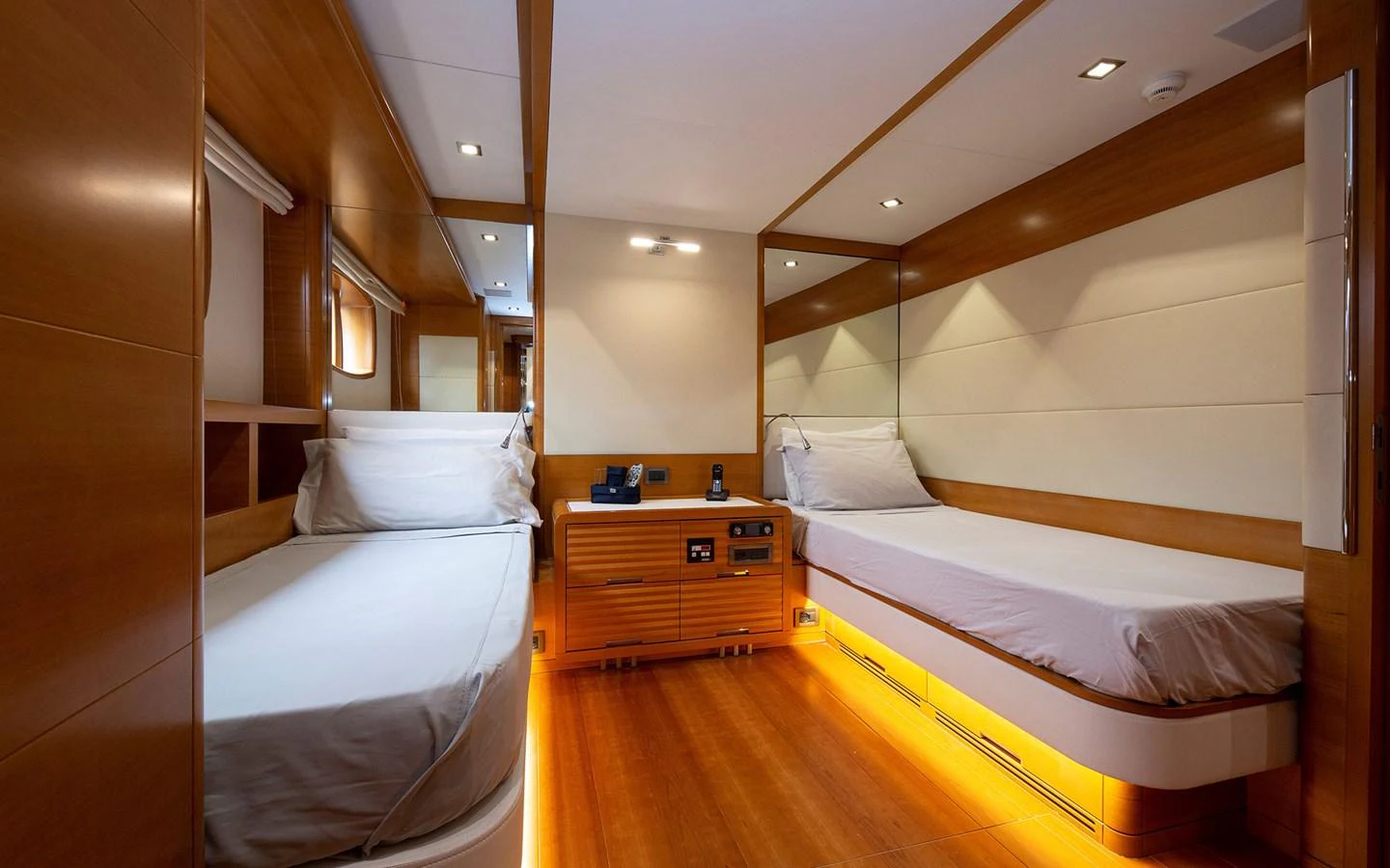 The twin stateroom features modern wooden paneling and ambient lighting for a cozy and elegant atmosphere. aboard SOFIA OF TORTOLA Yacht for Sale