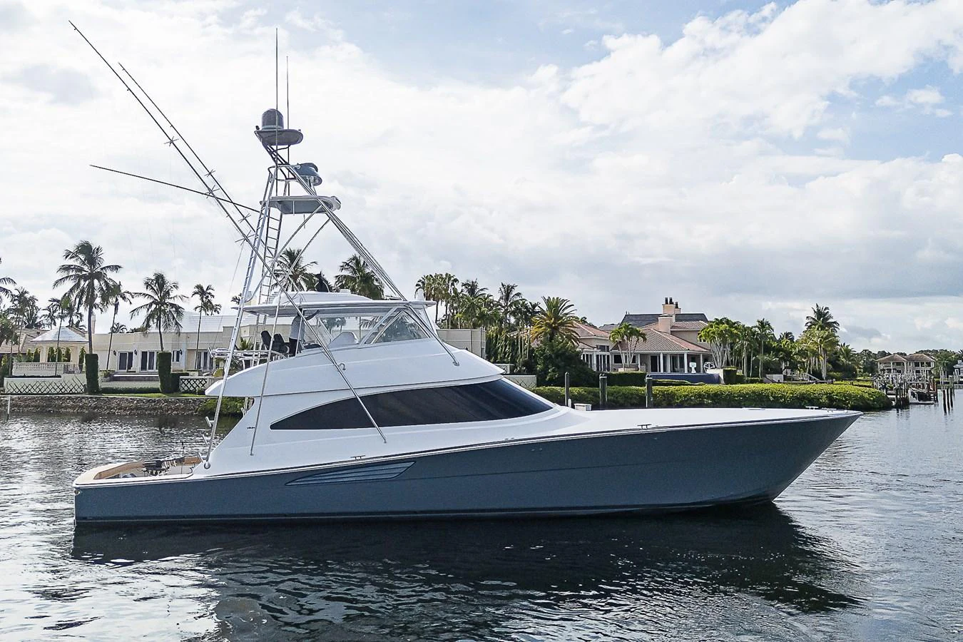 A sleek yacht with a modern design is docked in a serene waterfront setting. aboard LADY SURFBUM Yacht for Sale