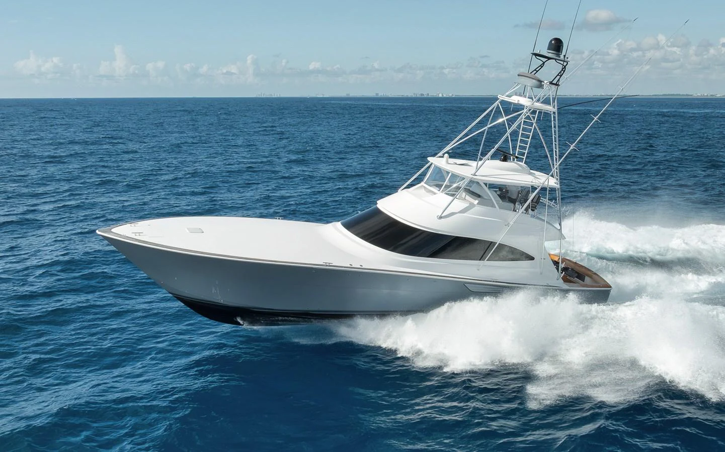A sleek yacht cuts through the open ocean with impressive speed and elegance. aboard LADY SURFBUM Yacht for Sale