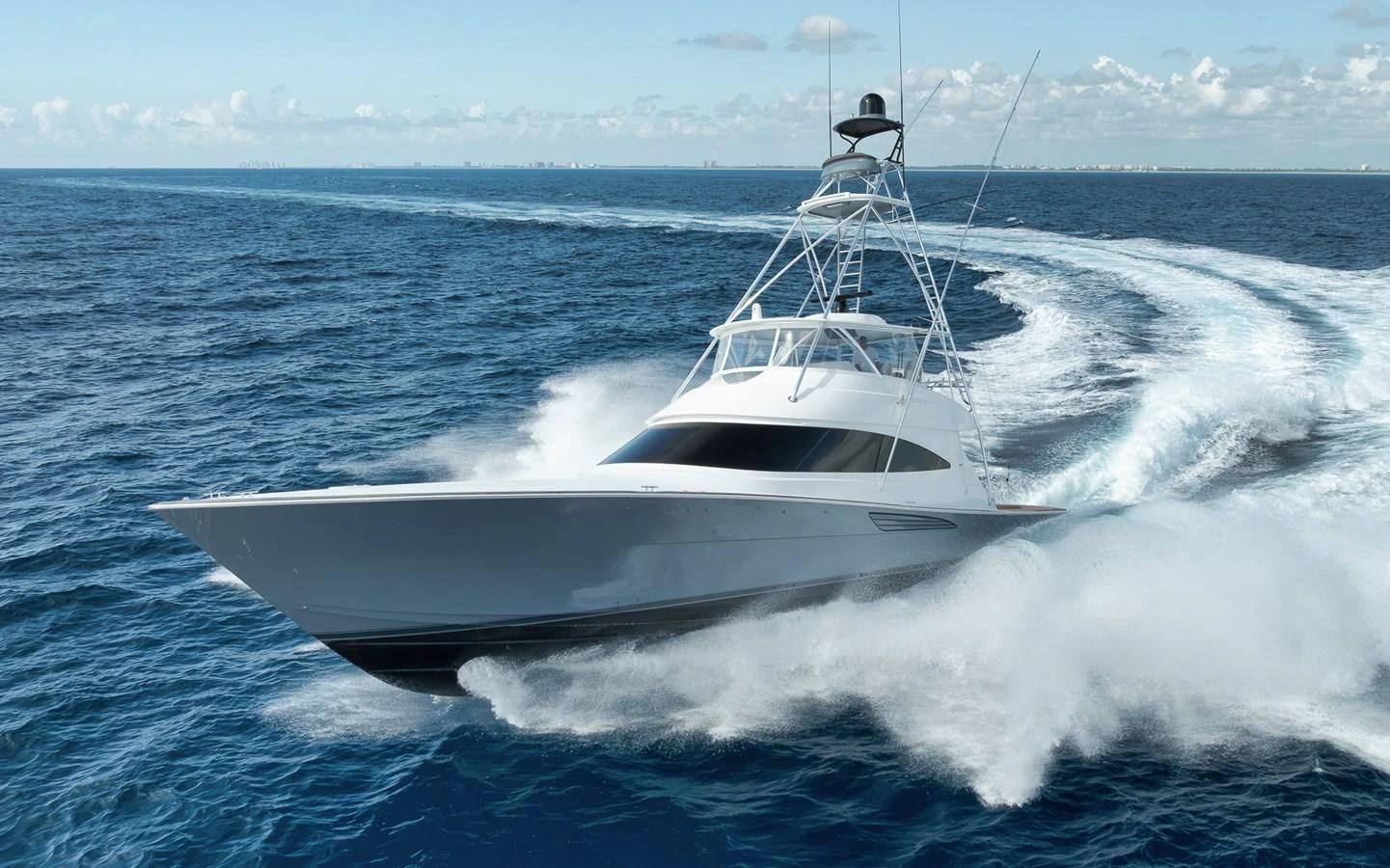A sleek yacht cuts through the water at high speed, showcasing its powerful performance. aboard LADY SURFBUM Yacht for Sale