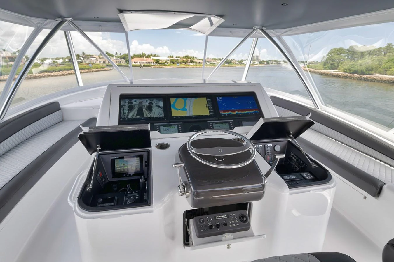The helm station offers a panoramic view with advanced navigation equipment and luxurious seating. aboard LADY SURFBUM Yacht for Sale
