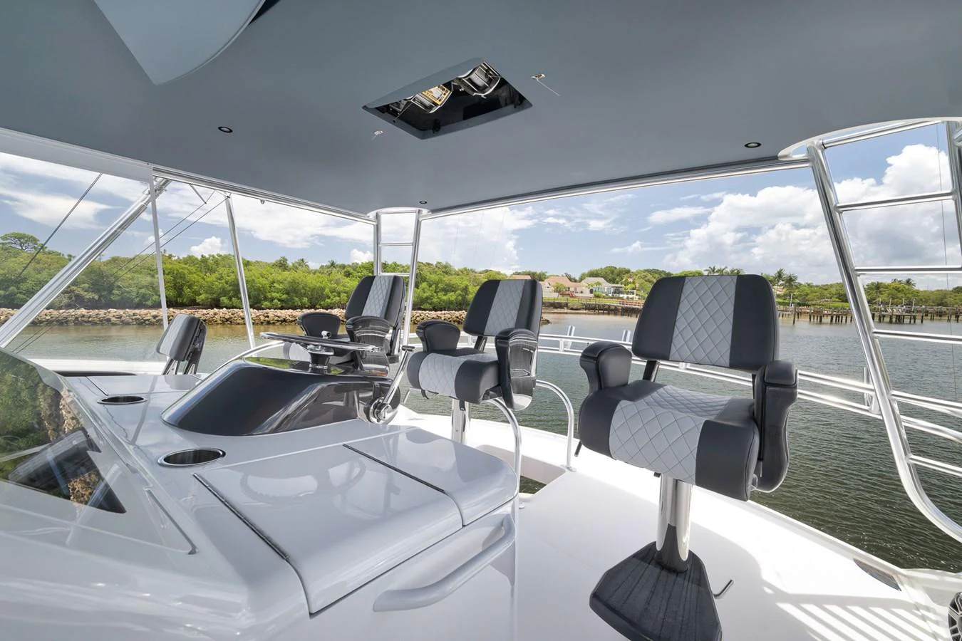 The flybridge offers a spacious and modern seating area with a scenic view. aboard LADY SURFBUM Yacht for Sale