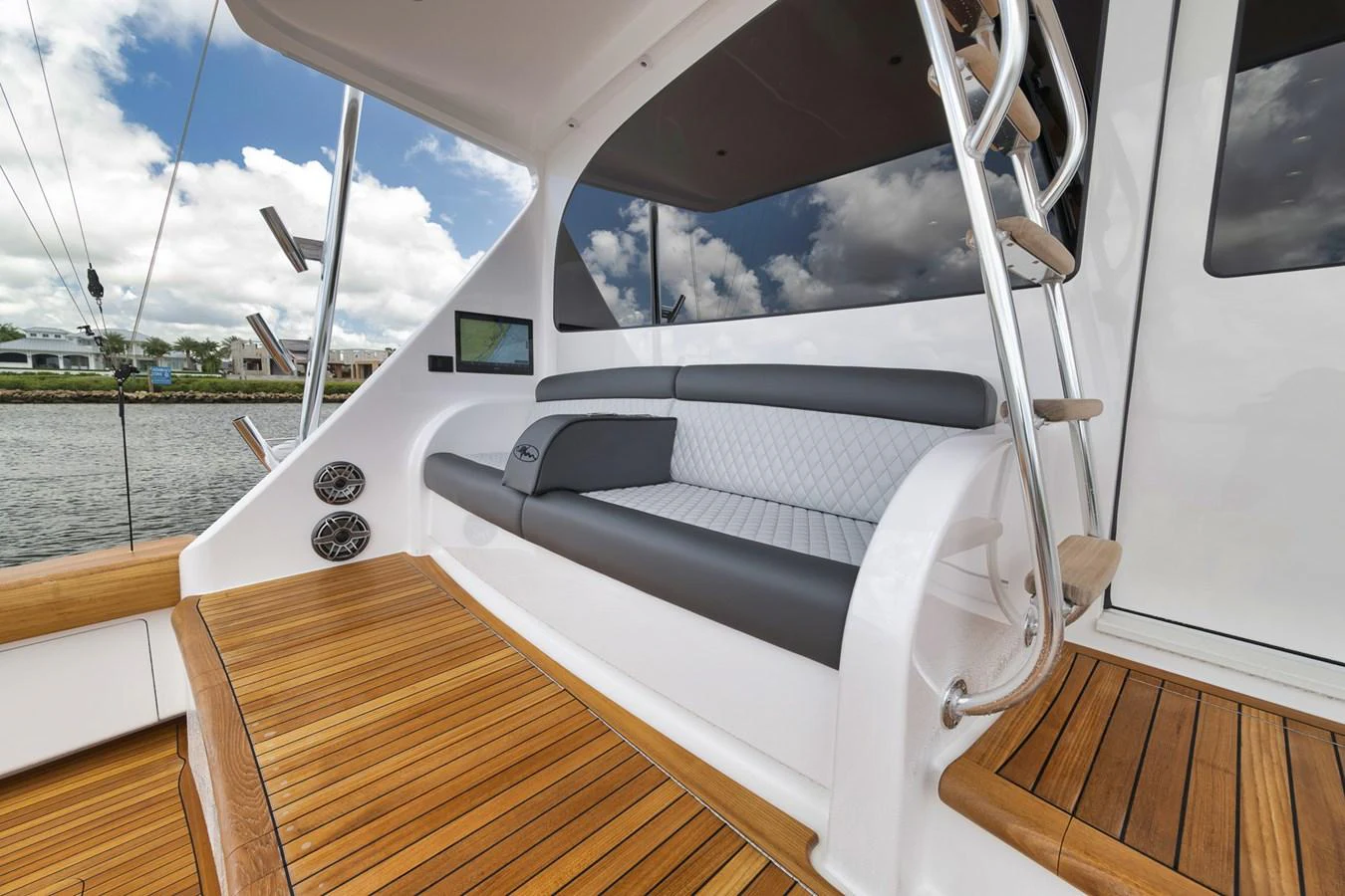 The aft deck features a stylish seating area with a blend of teak flooring and modern upholstery. aboard LADY SURFBUM Yacht for Sale