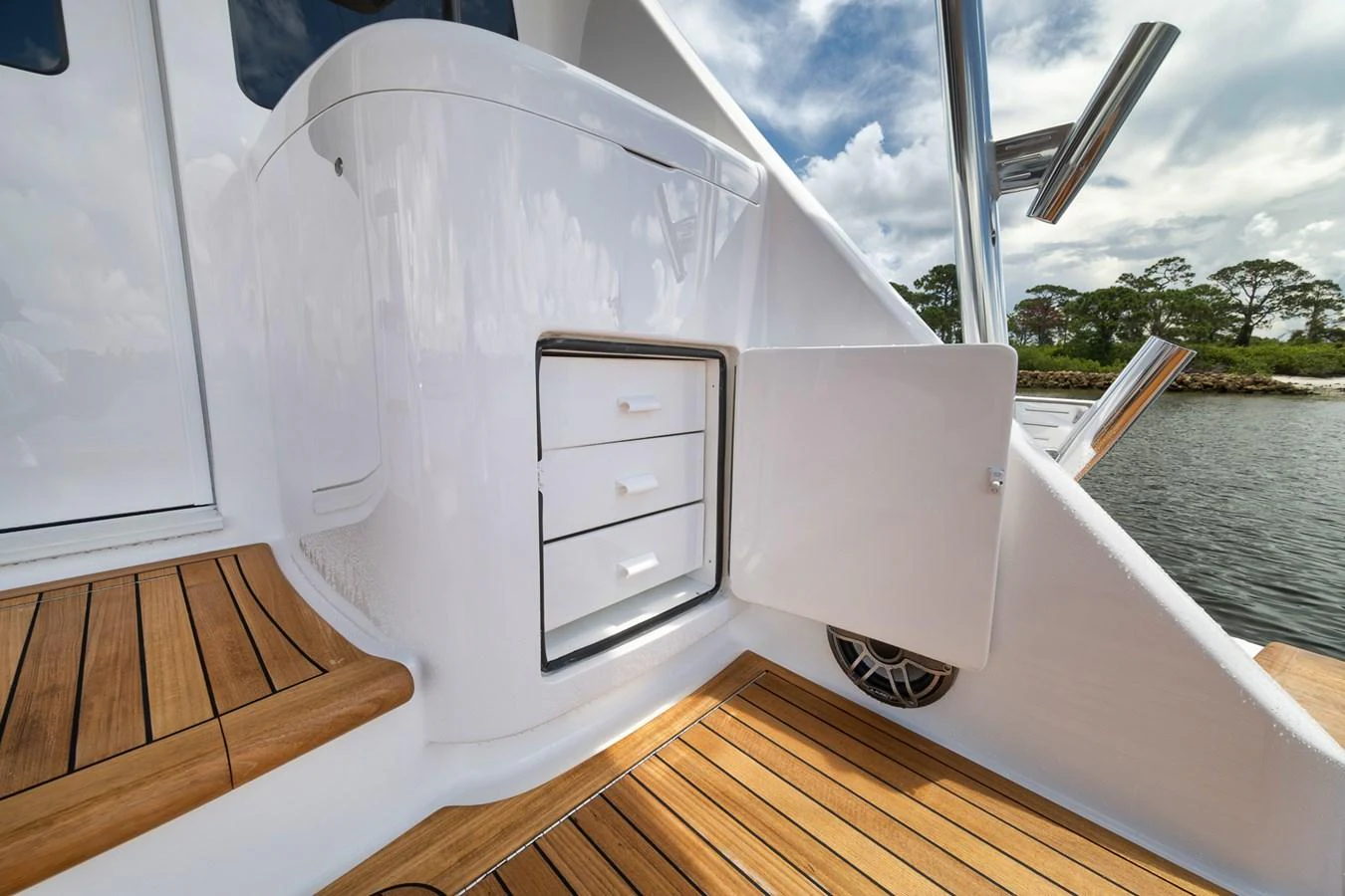 The image showcases a sleek storage area on the yacht's deck with polished wooden flooring and a scenic background. aboard LADY SURFBUM Yacht for Sale
