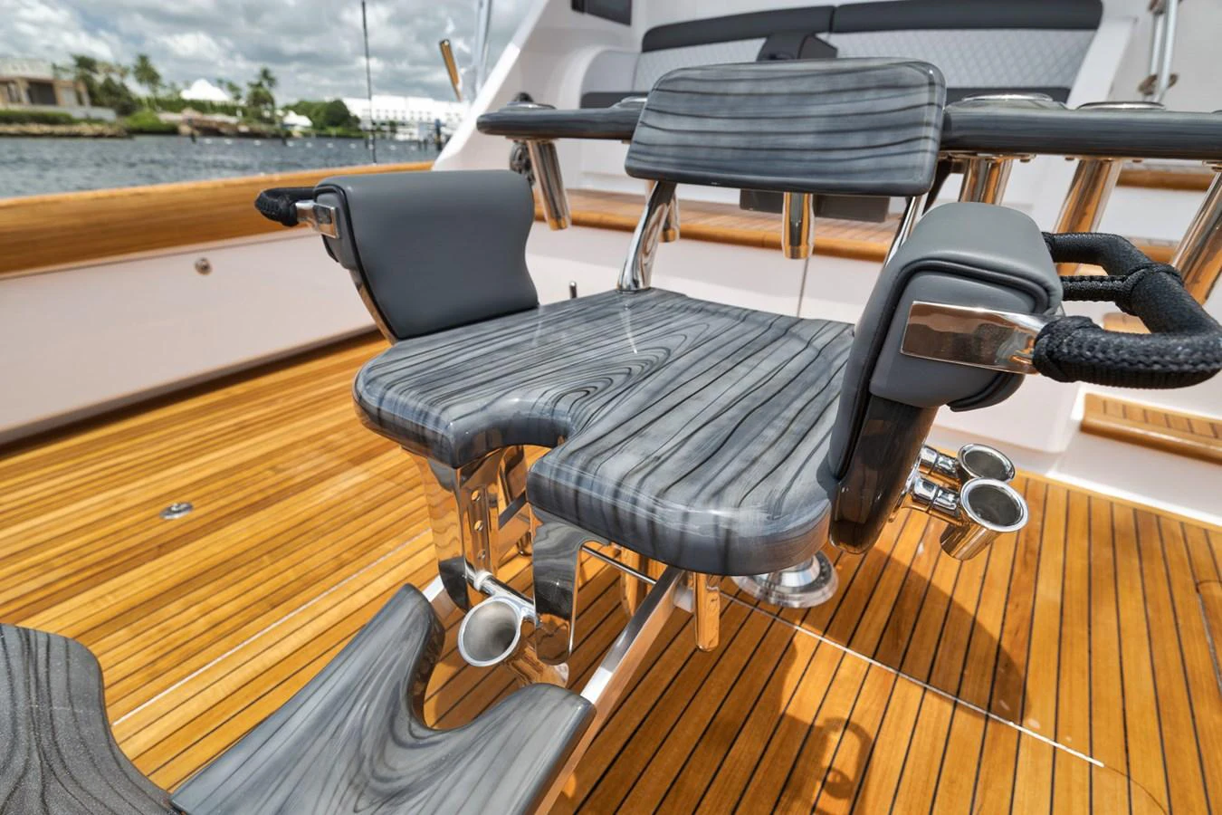 A close-up view of a luxurious fishing chair on the yacht's deck, showcasing fine woodwork and comfortable seating. aboard LADY SURFBUM Yacht for Sale