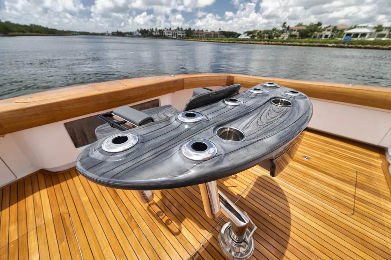 The aft deck features a stylish and functional fishing station with rod holders and a polished wood finish. aboard LADY SURFBUM Yacht for Sale