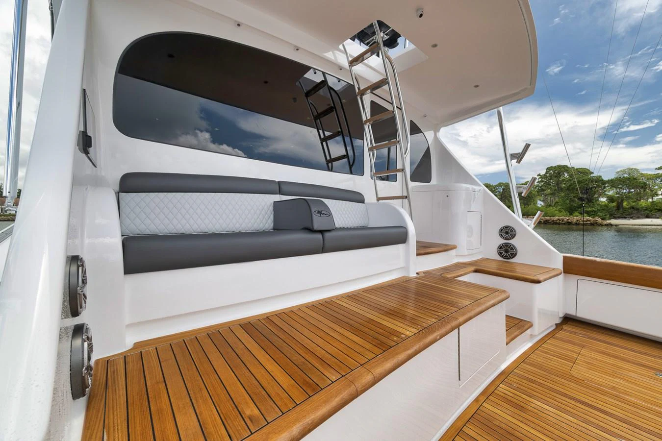 The aft deck features elegant teak flooring and comfortable seating, perfect for relaxation. aboard LADY SURFBUM Yacht for Sale