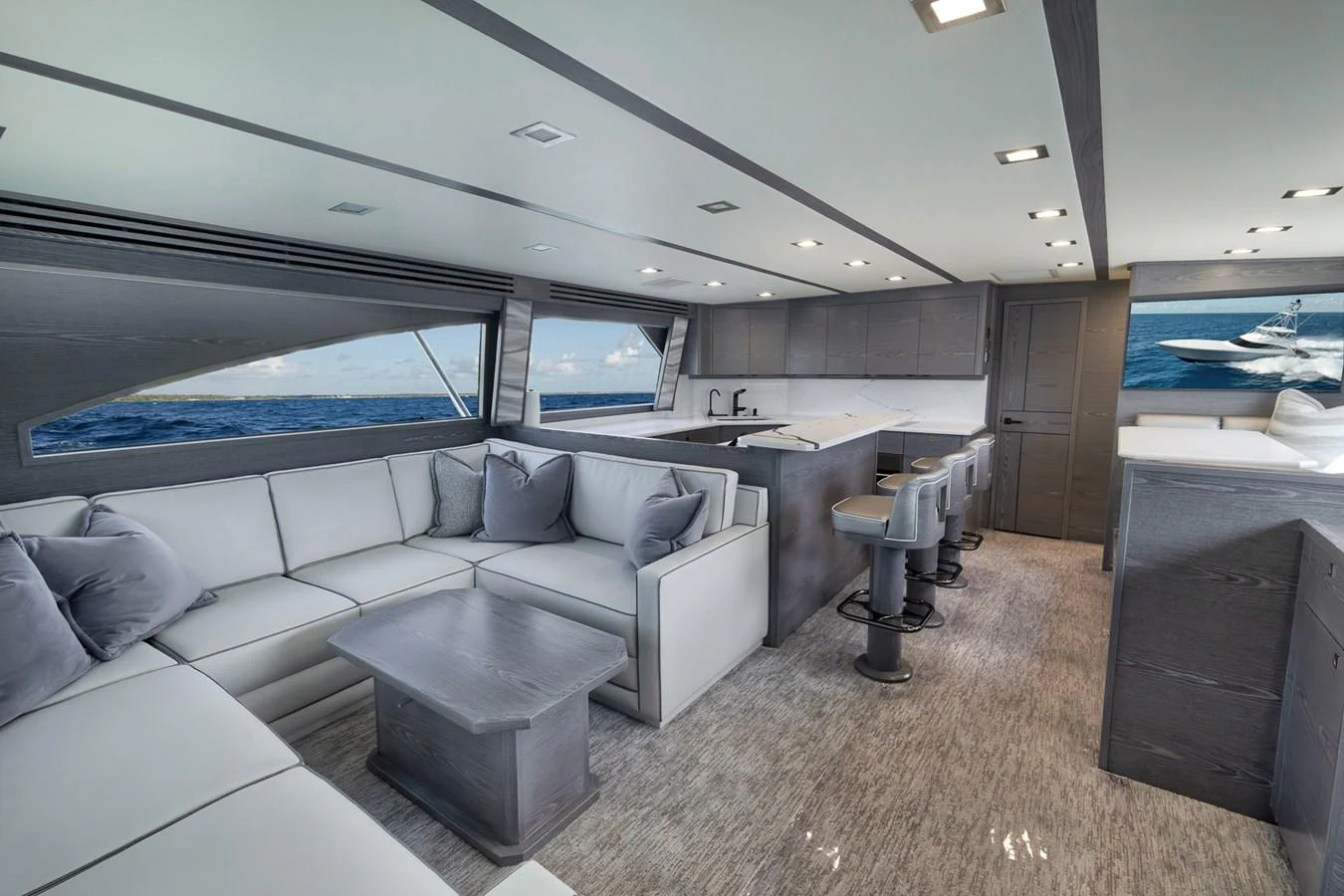 The salon features a spacious seating area with a modern, open layout and large windows offering stunning ocean views. aboard LADY SURFBUM Yacht for Sale