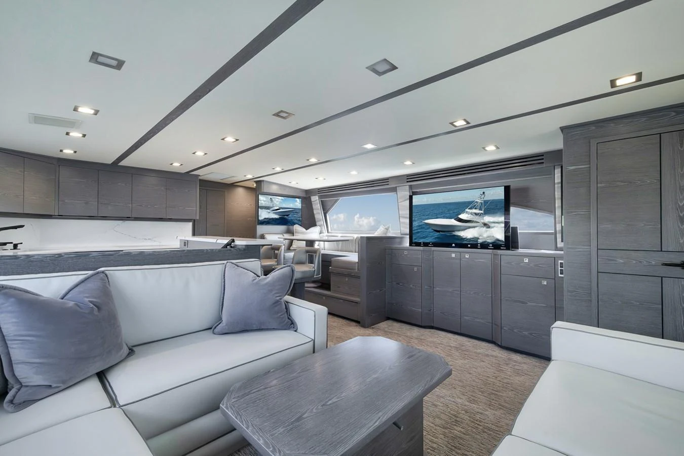 The salon features modern furnishings and large windows for an inviting and luxurious atmosphere. aboard LADY SURFBUM Yacht for Sale