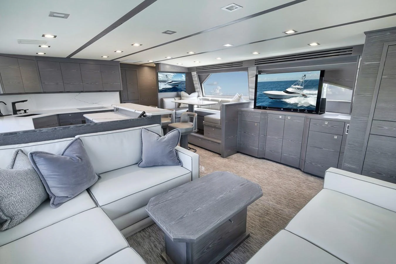 The salon features plush seating, modern cabinetry, and large windows offering stunning views. aboard LADY SURFBUM Yacht for Sale