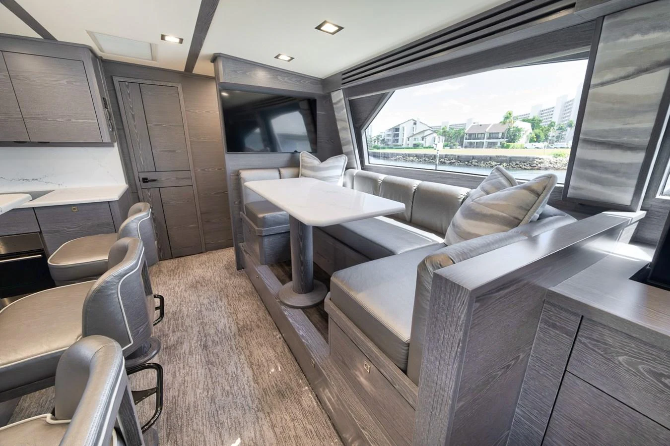 The yacht's saloon features a comfortable seating area with a dining table, offering a cozy and stylish environment. aboard LADY SURFBUM Yacht for Sale