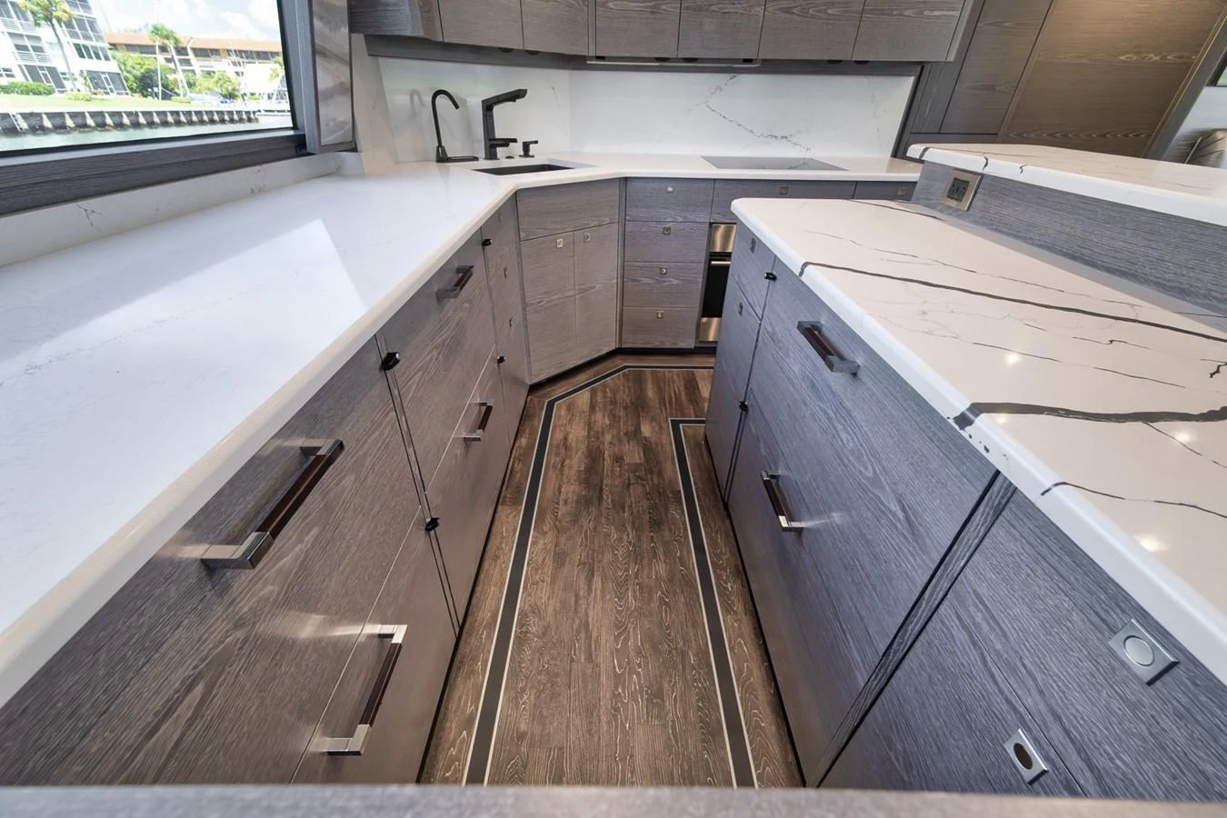 The yacht's galley features sleek cabinetry and modern appliances, creating a stylish and functional space. aboard LADY SURFBUM Yacht for Sale