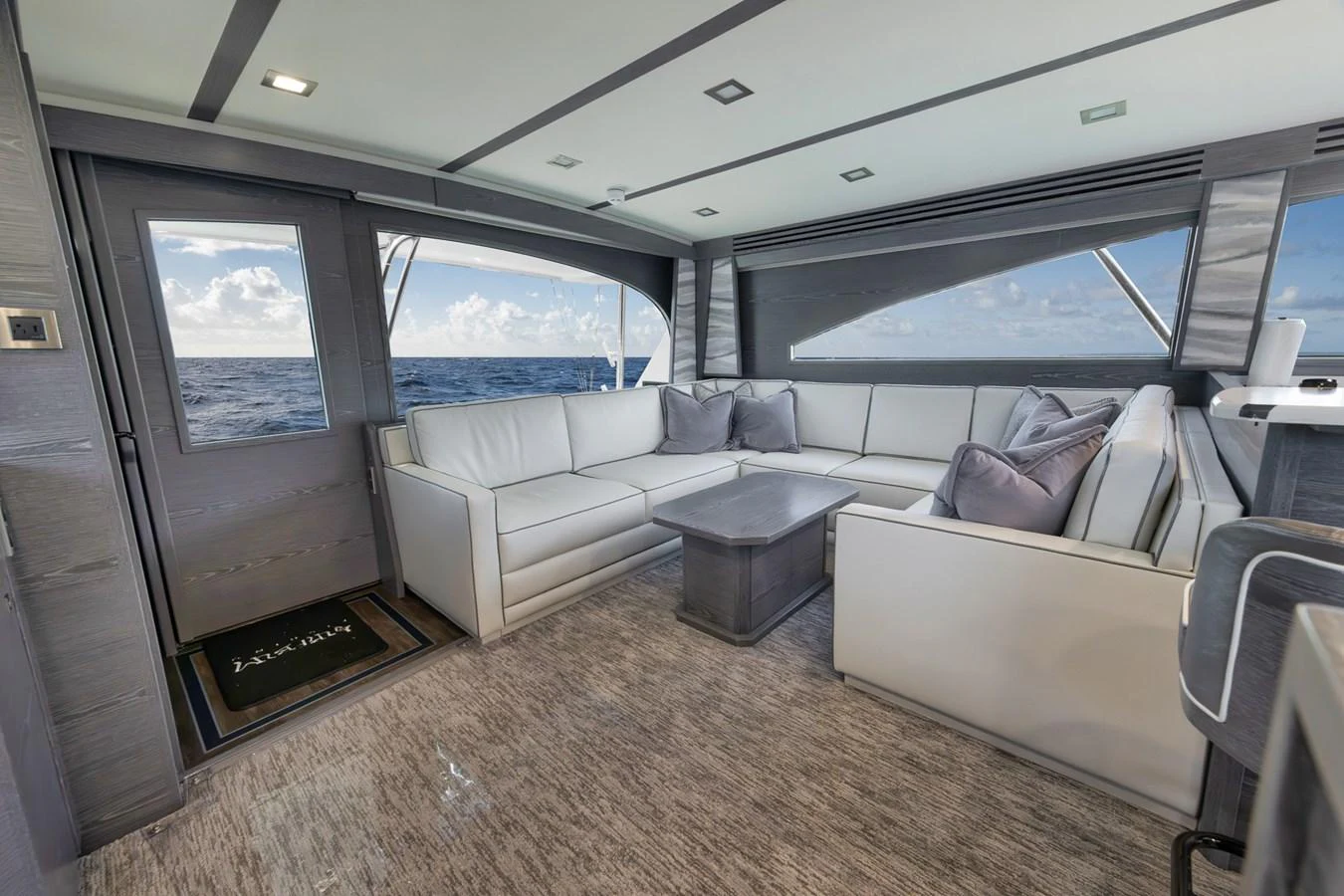 The salon features a spacious and elegant seating area with a stunning ocean view. aboard LADY SURFBUM Yacht for Sale