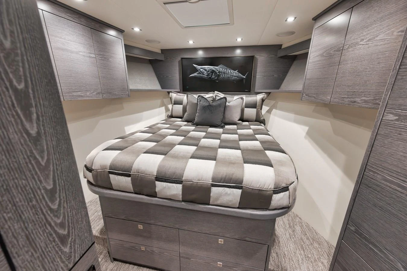 A luxurious stateroom featuring a plush bed with elegant bedding and ample storage space. aboard LADY SURFBUM Yacht for Sale