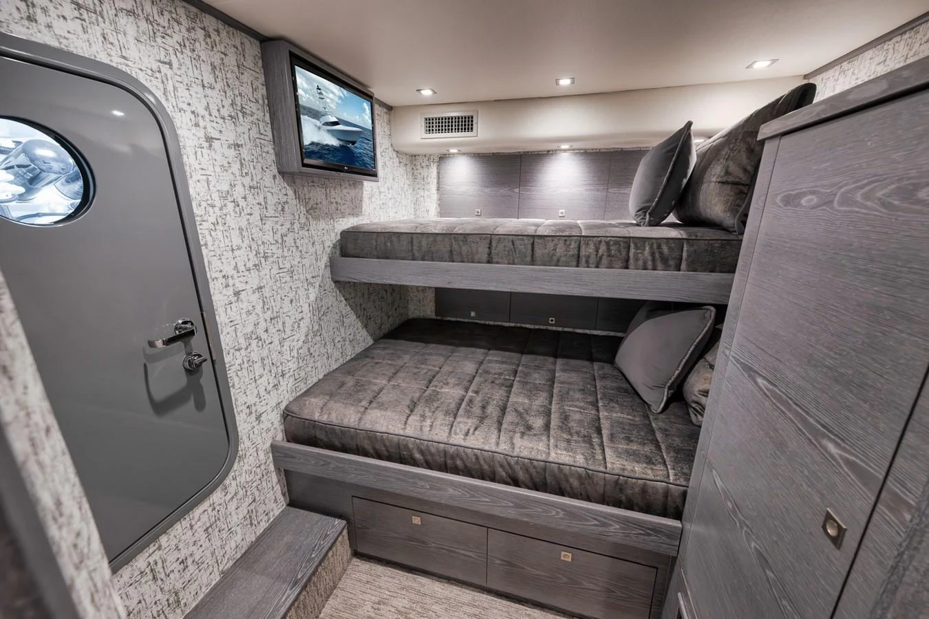 A cozy cabin with bunk beds and modern amenities. aboard LADY SURFBUM Yacht for Sale