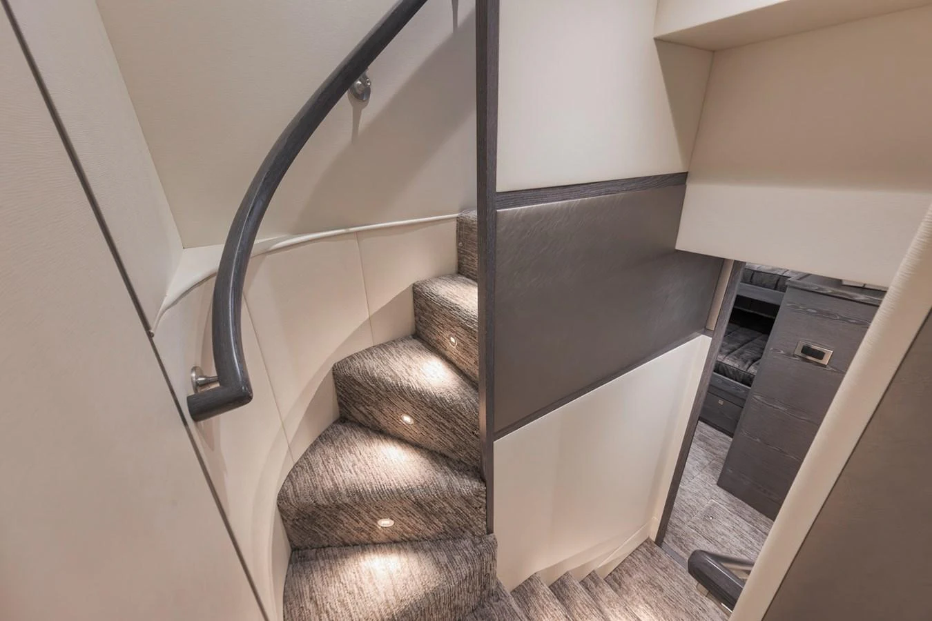 A stylishly designed staircase with modern lighting leads to the lower deck. aboard LADY SURFBUM Yacht for Sale