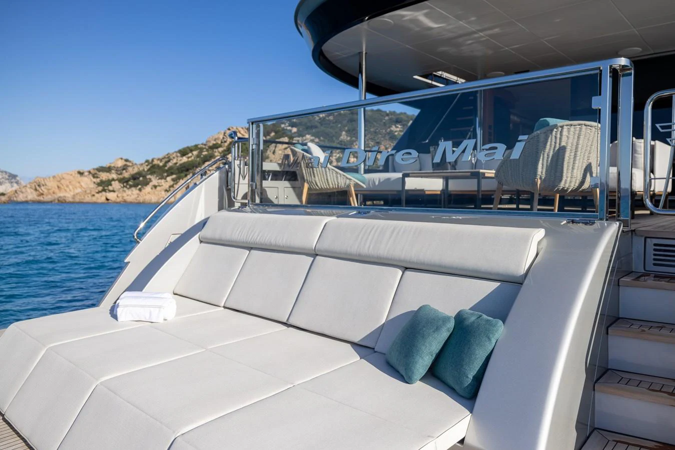 The yacht's aft deck features a luxurious sunbathing area with plush cushions and a stunning view of the surrounding waters. aboard FILIPPETTI F100-03 Yacht for Sale