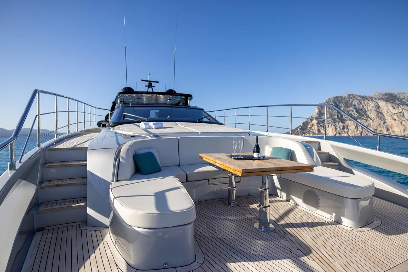 The foredeck features a stylish seating area with a table, perfect for enjoying the scenic views. aboard FILIPPETTI F100-03 Yacht for Sale