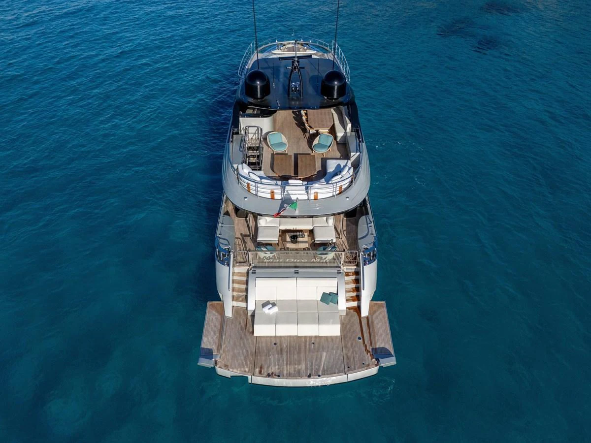 The yacht's aft deck offers a luxurious space for relaxation and entertainment, with a stunning view of the clear blue water. aboard FILIPPETTI F100-03 Yacht for Sale